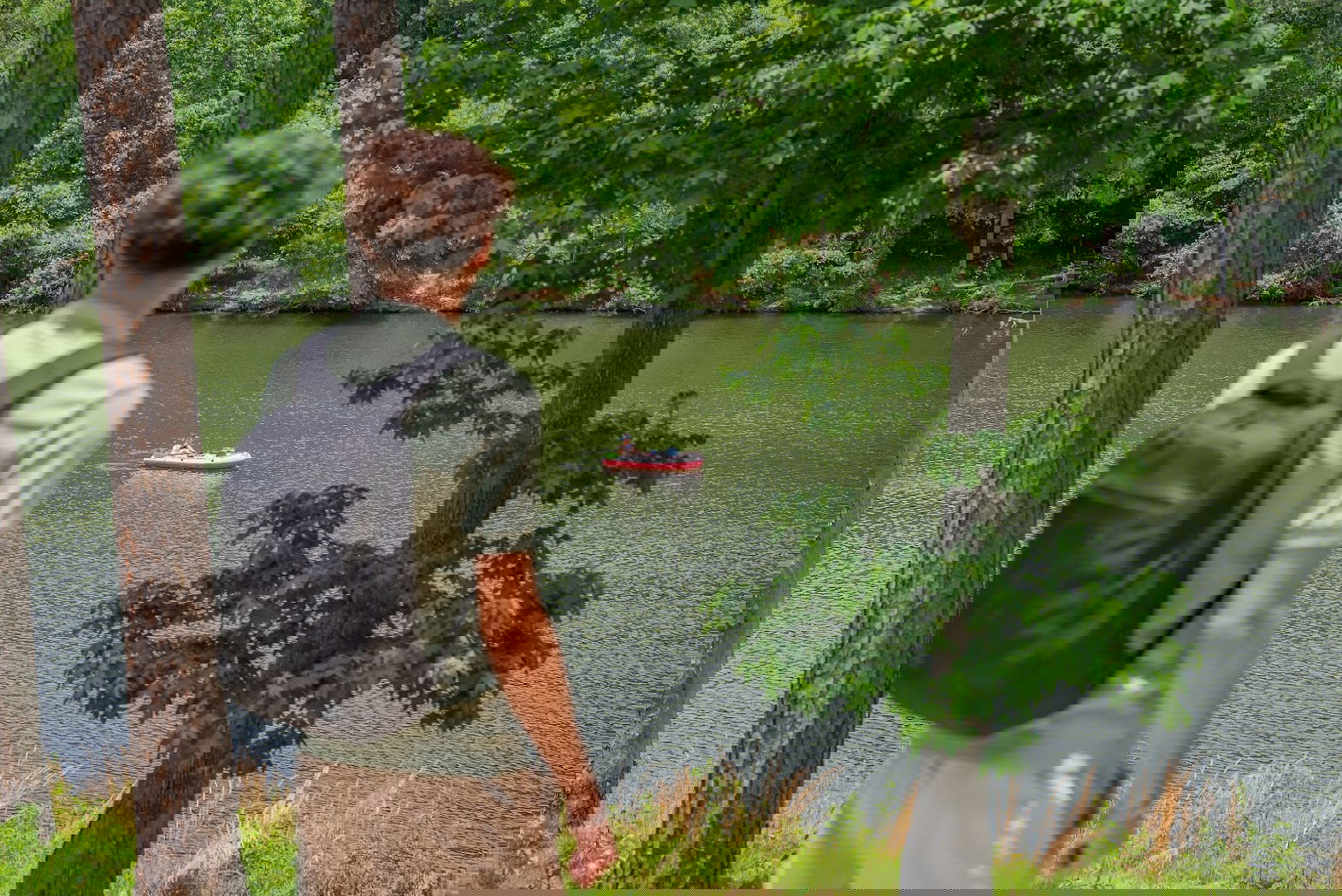 Person Hiking Overlooking a Lake